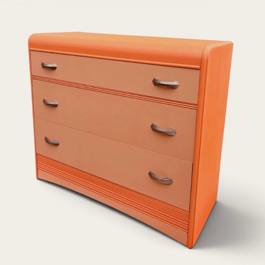 Angled view of the orange waterfall dresser