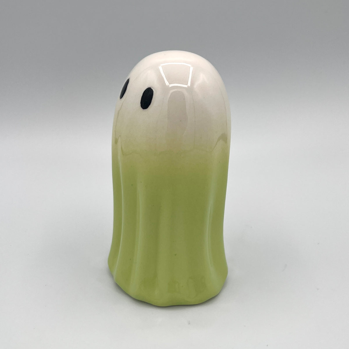 Green ghost figurine side view