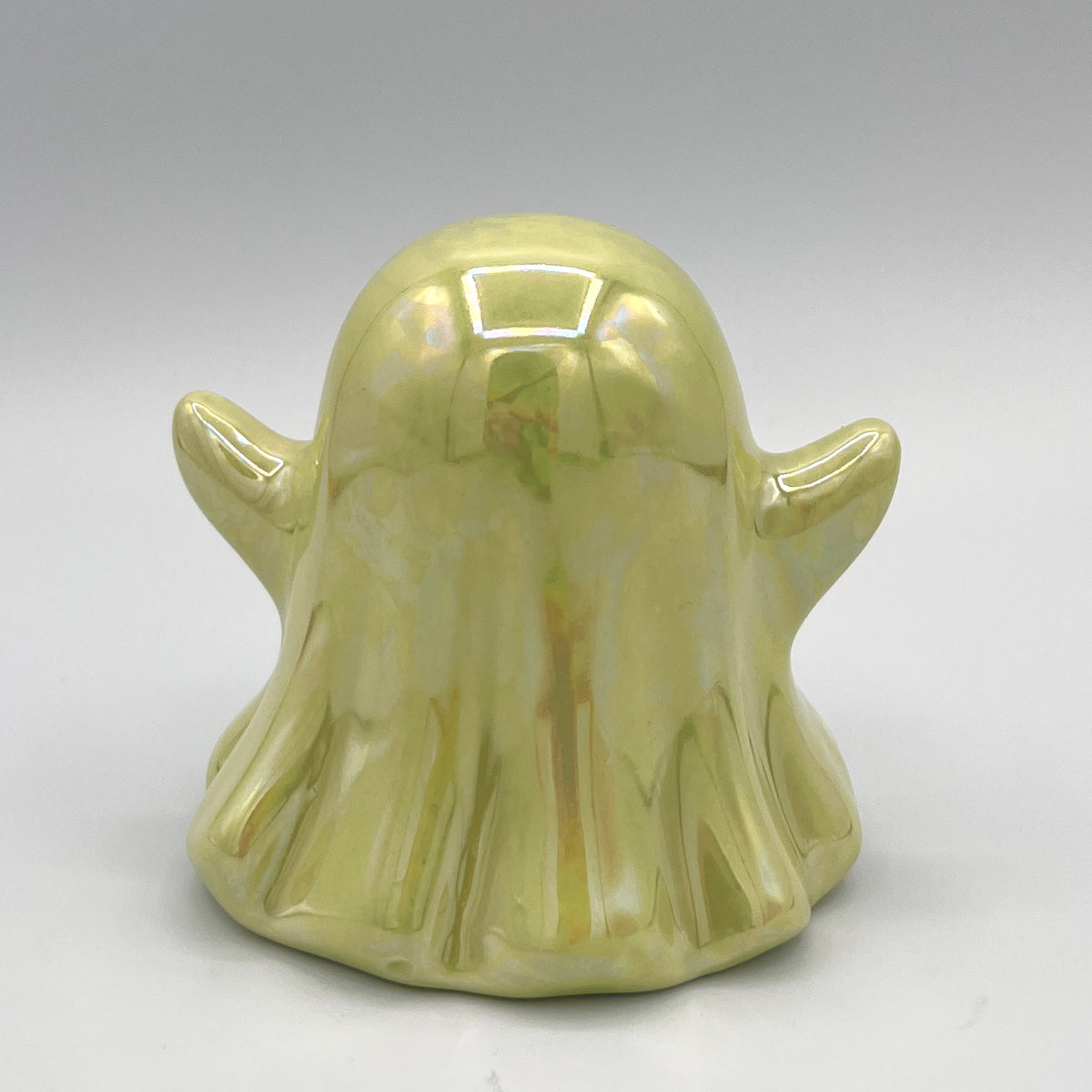 Lime green ghost figurine side view