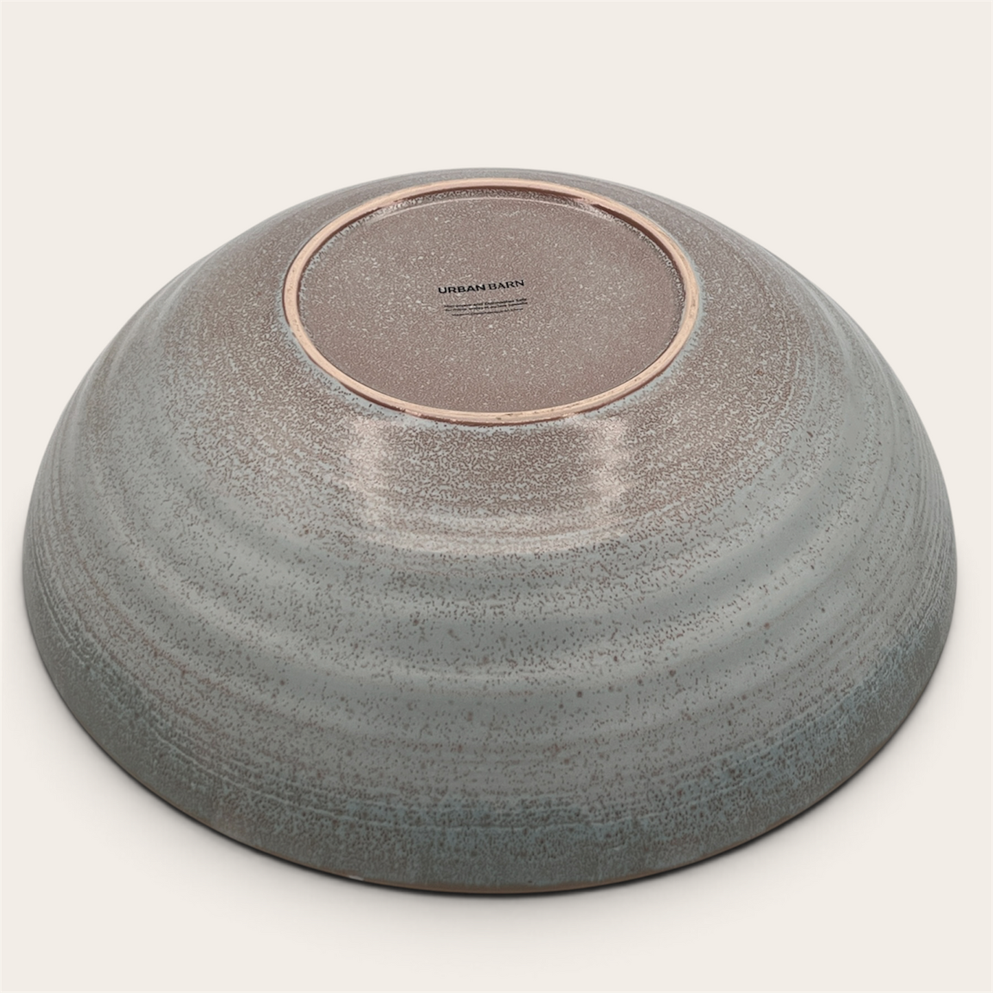 Reactive glaze stoneware serving bowl, bottom view showing Urban Barn stamp