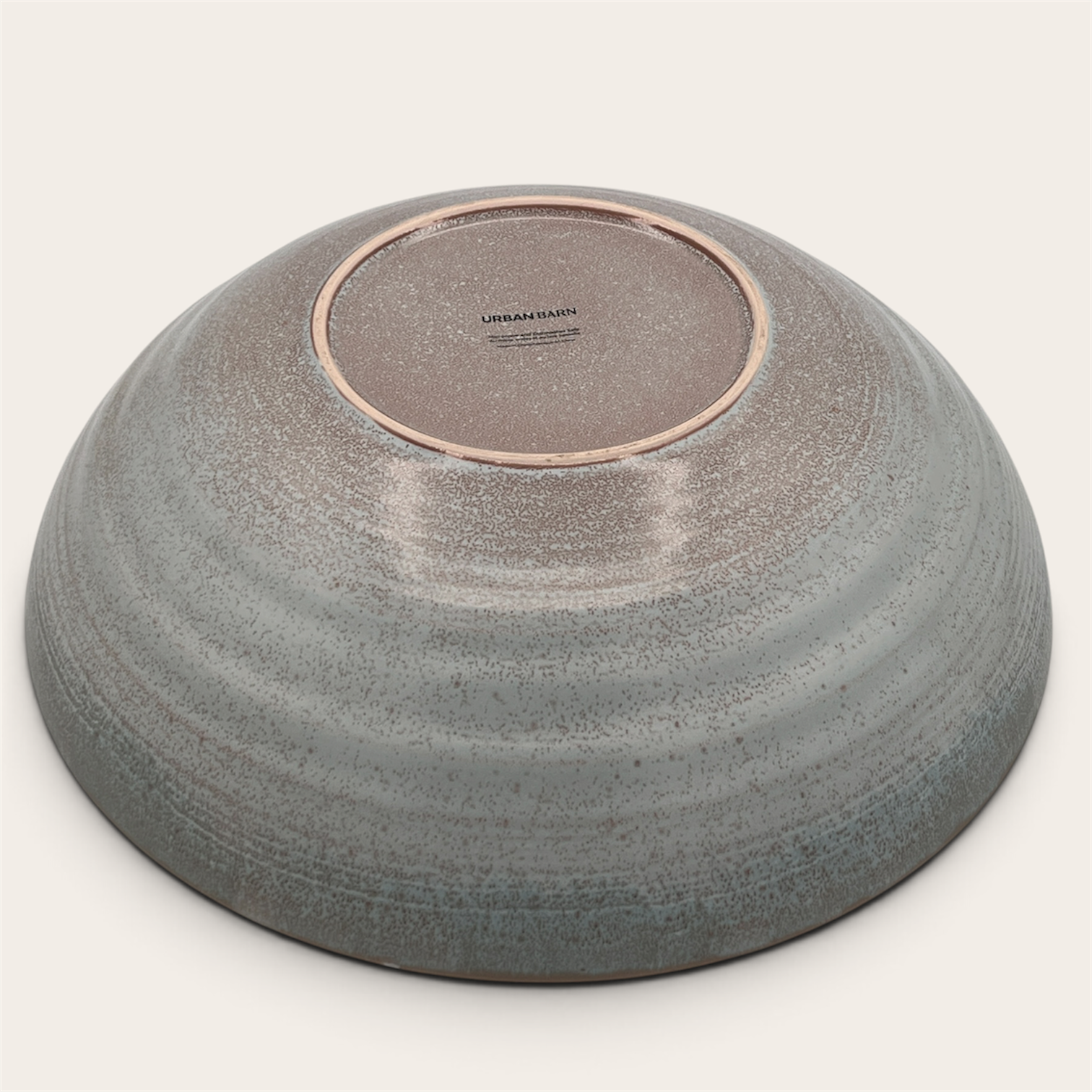 Reactive glaze stoneware serving bowl, bottom view showing Urban Barn stamp